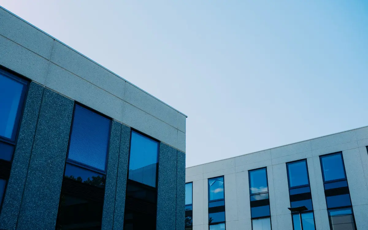 Low-angle view of modern commercial office buildings with reflective windows